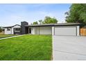 Beautiful single-story home with an attached garage, welcoming front porch, and manicured green lawn at 290 Beryl Way, Broomfield, CO 80020