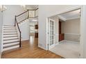 Inviting entryway with hardwood floors, staircase, and an open view to other rooms at 2250 Indian Paintbrush Cir, Highlands Ranch, CO 80129