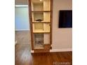 Built-in shelving unit with storage next to the TV mount at 7665 E Eastman Ave # 110C, Denver, CO 80231