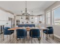 Elegant dining area featuring modern lighting and a seamless transition to the spacious kitchen at 16383 Ute Peak Way, Broomfield, CO 80023