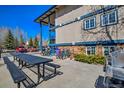 Exterior view of condos with community picnic tables, grill and bicycle storage at 214 N Main St # 14, Breckenridge, CO 80424