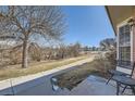 View of a large tree, sidewalk, and green space from the front patio at 2777 E Geddes Ave, Centennial, CO 80122