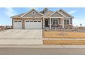 Two-story house with gray siding, stone accents, and a two-car garage at 15740 Spruce St, Thornton, CO 80602