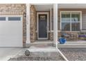 Attractive front entrance with stone pillars and a dark gray door at 15740 Spruce St, Thornton, CO 80602