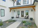 Charming front porch with seating, decorative plants, a pathway, and stylish exterior details at 609 Pioneer Camp Vw, Palmer Lake, CO 80133