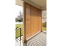 Inviting front porch with wood slat wall and a view of the well-maintained front yard and neighborhood at 4631 Zuni St, Denver, CO 80211