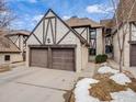 Attractive townhomes with unique Tudor details, paired garages and landscaped surroundings at 4250 S Olive St # 108, Denver, CO 80237