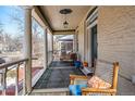 Welcoming front porch with cozy seating, brick flooring, and decorative columns at 1368 N Gilpin St, Denver, CO 80218