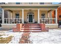 Inviting front porch with brick steps, rocking chairs, and white columns at 1368 N Gilpin St, Denver, CO 80218