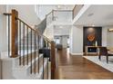 A bright foyer features a staircase, wood floors, an accent wall, and an upper level gallery at 16371 Jones Mountain Way, Broomfield, CO 80023