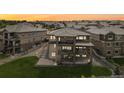 Spacious two-story home with multiple balconies, a patio, stairs and a grass covered backyard at 16371 Jones Mountain Way, Broomfield, CO 80023