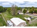 Overhead view of property featuring outbuildings, mature trees, a well-kept lawn, and a perimeter fence at 3784 Whitetail Ct, Mead, CO 80542