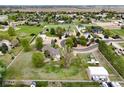 Wide aerial view of a sprawling estate with white fencing, multiple structures and established landscaping at 3784 Whitetail Ct, Mead, CO 80542