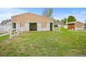 Tan barn with two large doors and a smaller shed nearby at 3784 Whitetail Ct, Mead, CO 80542