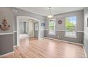 Bright dining room with hardwood floors and an arched doorway at 3784 Whitetail Ct, Mead, CO 80542