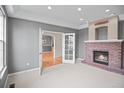 Living room with a brick fireplace and French doors at 3784 Whitetail Ct, Mead, CO 80542