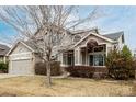 Attractive two-story home featuring a two-car garage and mature landscaping at 664 Clarendon Dr, Longmont, CO 80504
