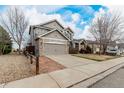Beautiful home exterior with a two-car garage, fenced yard and a paved driveway at 664 Clarendon Dr, Longmont, CO 80504