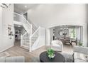 Open-concept living area with a staircase, neutral decor, and views into the dining room at 664 Clarendon Dr, Longmont, CO 80504