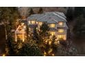 Luxury two-story home surrounded by mature trees and beautiful landscaping at 22419 Springflower Dr, Golden, CO 80401