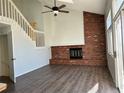 Open living room with brick fireplace and hardwood floors at 17548 E Wesley Pl, Aurora, CO 80013