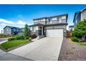 Two-story home with a well-maintained lawn, complemented by fresh landscaping and an attached garage at 350 Vista Cliff Cir, Castle Rock, CO 80104