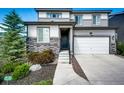 Charming two-story home with a beautiful stone accent, an attached two-car garage and landscaped front yard at 350 Vista Cliff Cir, Castle Rock, CO 80104