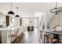 Bright, open-concept living space showcasing modern finishes, wood floors, and an adjacent dining area at 6068 Beeler Ct, Denver, CO 80238