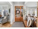 Bright and airy entryway with hardwood floors and a charming wooden bench at 11765 Perry St, Westminster, CO 80031