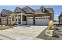 Lovely home with stone accents, a covered porch, a two-car garage and a large driveway at 15747 Willow Way, Thornton, CO 80602