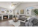 Bright living room featuring vaulted ceilings, a fireplace, and comfortable seating at 12935 Lafayette St # B, Thornton, CO 80241