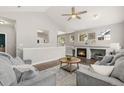 Spacious living room boasts a fireplace, vaulted ceilings, and an open layout at 12935 Lafayette St # B, Thornton, CO 80241