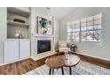 Cozy living room featuring a fireplace, large windows, and neutral decor, creating a comfortable space at 8791 Troon Village Pl, Lone Tree, CO 80124