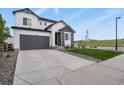 Attractive home with a stone facade, gray garage door, and a well-manicured lawn at 5446 Coltin Trl, Castle Rock, CO 80104