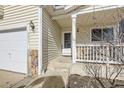 A view of the front porch with stone accents and exterior lights at 9617 Bighorn Way, Littleton, CO 80125