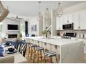 Bright kitchen and living room with a marble island, modern appliances, open concept layout, and lots of natural light at 888 S Valentia St # 103, Denver, CO 80247