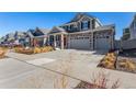 Stunning two-story home with a large driveway, stone accents, and modern design elements at 4104 N Picadilly Ct, Aurora, CO 80019
