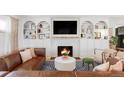 Cozy living room with a fireplace, built-in shelving, and stylish furnishings at 6567 S Elizabeth Way, Centennial, CO 80121