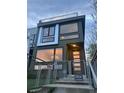 Eye-catching home with oversized windows and an elevated rooftop terrace, secured by a metal fence and front gate at 3333 Osage St, Denver, CO 80211