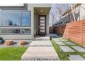 Inviting front entrance with concrete walkway, rock features and a modern, dark wood front door at 3333 Osage St, Denver, CO 80211