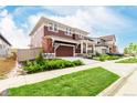 Two-story home with a covered porch, attached garage, and an inviting curb appeal at 1826 Hickory Ave, Erie, CO 80516