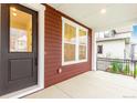 Covered front porch with decorative columns and black metal railings at 1826 Hickory Ave, Erie, CO 80516