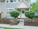 Inviting front porch with a charming chair and decorative wreath on the front door at 208 N Foote Ave, Lafayette, CO 80026