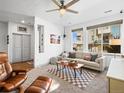 Sun-filled living room with neutral palette, modern decor, and large windows for natural light at 5738 Urban Ctr, Arvada, CO 80002