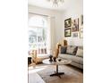 Cozy living room with hardwood floors, large windows, comfortable seating, and stylish decor at 321 Fox St, Denver, CO 80223