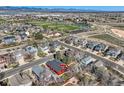 A neighborhood aerial view showcases a red home among tree-lined streets, near parks and green spaces at 9408 High Cliffe St, Highlands Ranch, CO 80129