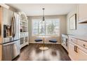 Cozy breakfast nook featuring a marble table set, bright window view and elegant cabinetry at 9408 High Cliffe St, Highlands Ranch, CO 80129