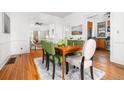 The dining room showcases hardwood floors and neutral décor with an adjacent kitchen at 1723 E 16Th Ave, Denver, CO 80218