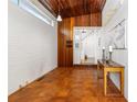 Spacious entryway with tile flooring, brick accent wall, coat racks, and natural light creating a welcoming atmosphere at 1723 E 16Th Ave, Denver, CO 80218