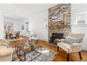 Inviting living room featuring a stone fireplace, hardwood floors, and ample natural light at 1723 E 16Th Ave, Denver, CO 80218